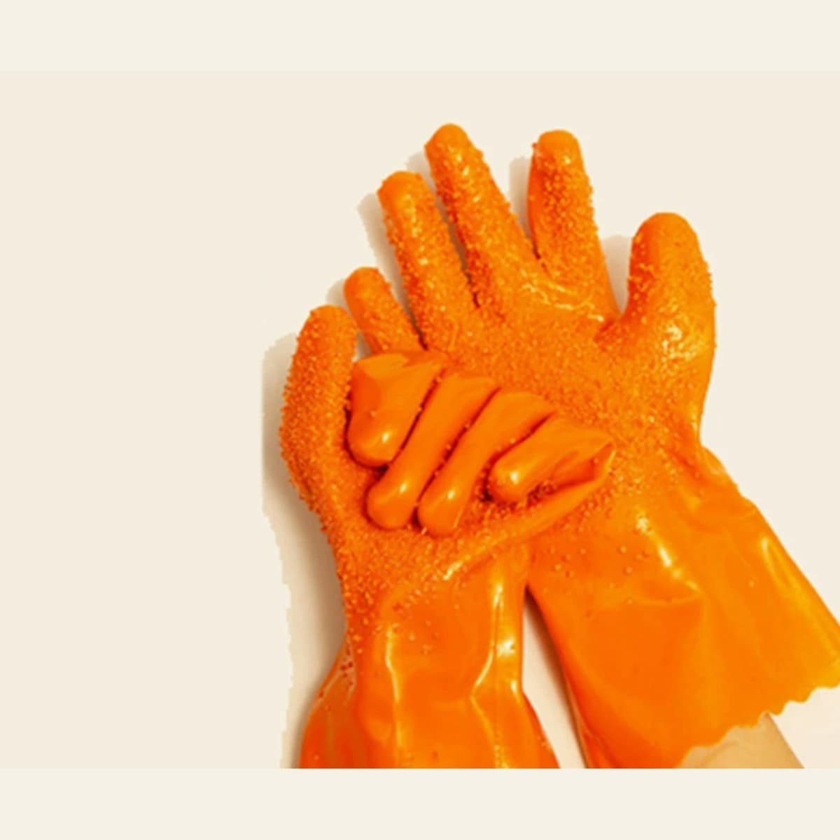 Orange PVC-coated work gloves worn with textured grip surface