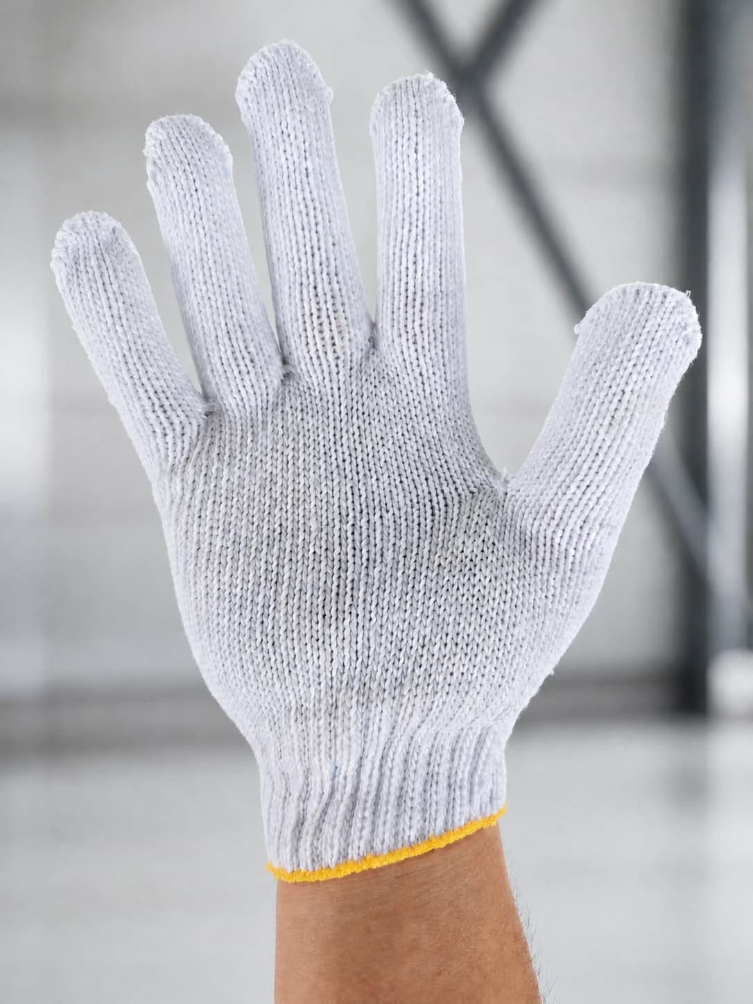 Bleached cotton string glove worn on hand, front view