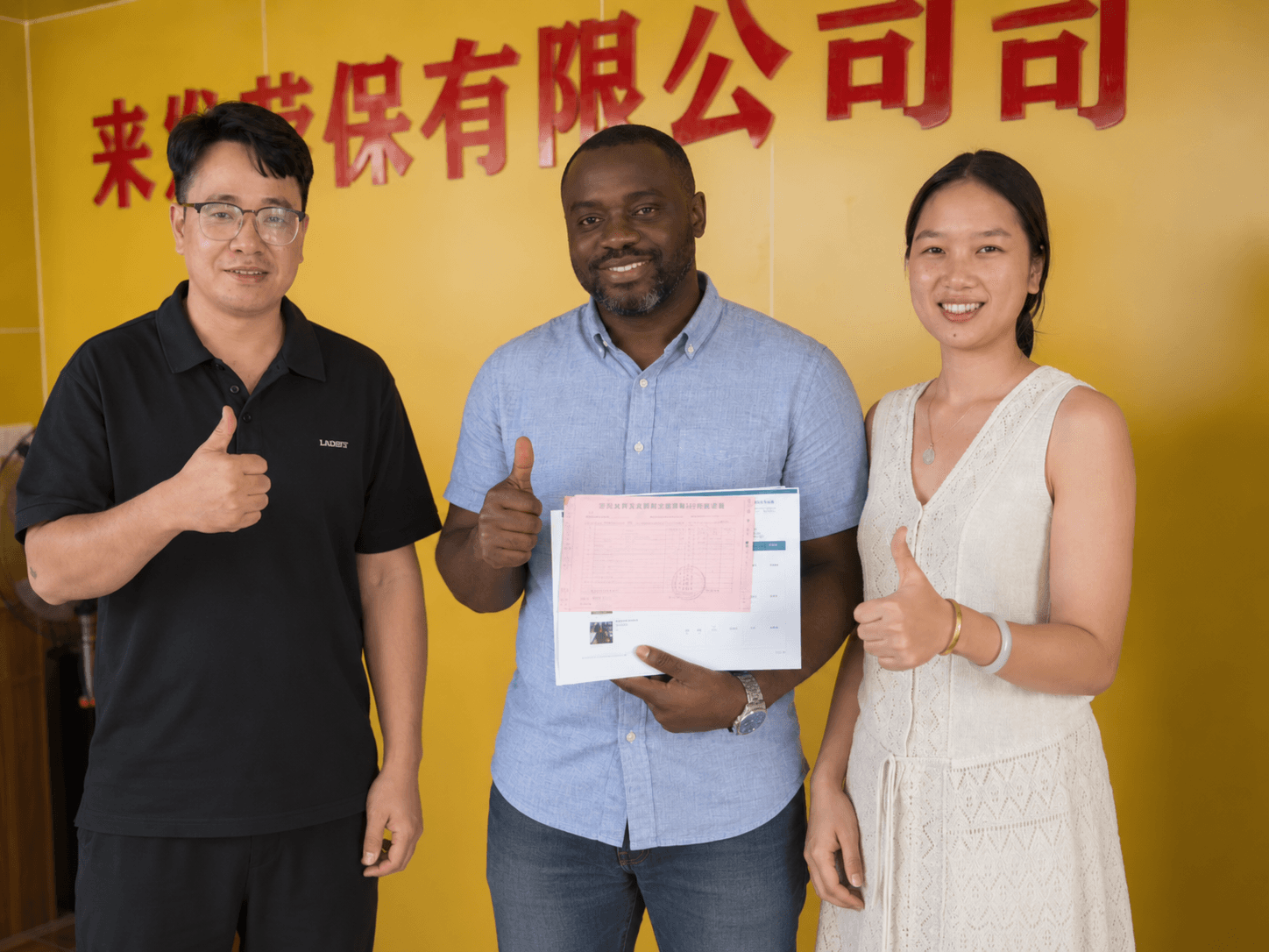 The buyer and LAIFAPPE team posing together with paperwork during the visit.
