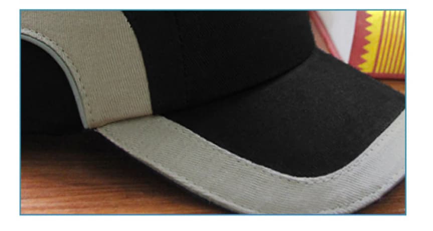 Curved brim, grey trim and stitching close-up